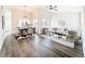 Inviting living and dining area featuring modern lighting, open layout, and stylish hardwood flooring at 2160 Churchill Downs Cir, Orlando, FL 32825