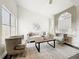 Living room showcasing ample natural light, neutral decor, and hardwood floors complemented by modern furniture at 2160 Churchill Downs Cir, Orlando, FL 32825