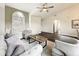 Bright living room featuring vaulted ceilings, ample seating, and a large arched window at 2160 Churchill Downs Cir, Orlando, FL 32825