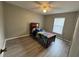 Comfortable bedroom with wood floors, ceiling fan, and a single bed at 258 Magellan Dr, Kissimmee, FL 34758