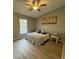 Cozy bedroom with wood floors, ceiling fan, and a comfortable bed at 258 Magellan Dr, Kissimmee, FL 34758