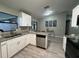 Modern kitchen with white cabinets, stainless steel appliances, granite countertops, and wood flooring at 258 Magellan Dr, Kissimmee, FL 34758