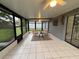 Enclosed lanai with tiled flooring, ceiling fans, and comfortable seating, offering a relaxing outdoor space at 258 Magellan Dr, Kissimmee, FL 34758