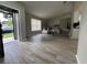 Bright living room with wood floors, vaulted ceilings, and comfortable seating, open to the kitchen at 258 Magellan Dr, Kissimmee, FL 34758