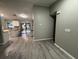 Open-concept space showcasing the kitchen, dining area, and entryway with wood flooring at 258 Magellan Dr, Kissimmee, FL 34758