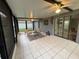 Bright sunroom featuring tile flooring, ceiling fan, and sliding glass doors leading inside at 258 Magellan Dr, Kissimmee, FL 34758