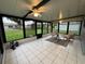 Bright sunroom with tile flooring, ceiling fan, and views of the backyard at 258 Magellan Dr, Kissimmee, FL 34758
