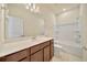 Well lit bathroom featuring a vanity, mirror, toilet, and shower-tub combo at 2601 Blowing Breeze Ave, Kissimmee, FL 34744