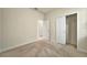 Clean, carpeted bedroom with closet and connecting doorway for easy access at 2601 Blowing Breeze Ave, Kissimmee, FL 34744