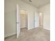 Carpeted bedroom features a walk-in closet and a door to the ensuite bathroom at 2601 Blowing Breeze Ave, Kissimmee, FL 34744