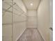 Empty walk-in closet with carpet flooring and wire shelving at 2601 Blowing Breeze Ave, Kissimmee, FL 34744