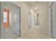 Hallway leading to various rooms, showcasing neutral colors and clean finishes at 2601 Blowing Breeze Ave, Kissimmee, FL 34744