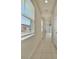 Bright hallway with neutral walls and a window bringing in natural light at 2601 Blowing Breeze Ave, Kissimmee, FL 34744