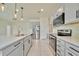 Spacious kitchen featuring gray cabinets and stainless steel appliances at 2601 Blowing Breeze Ave, Kissimmee, FL 34744