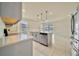 Modern kitchen featuring stainless steel appliances and gray cabinets at 2601 Blowing Breeze Ave, Kissimmee, FL 34744