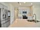 Well-lit kitchen with gray cabinets, a large sink, and stainless steel appliances at 2601 Blowing Breeze Ave, Kissimmee, FL 34744