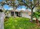 Private backyard featuring green lawn, partial fence, and lush surrounding trees at 2679 Rainbow Springs Ln, Orlando, FL 32828