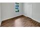 Comfortable bedroom featuring hardwood flooring, a window, and a closet at 2679 Rainbow Springs Ln, Orlando, FL 32828