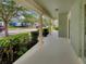 Inviting front porch featuring classic columns and views of the landscaped front yard at 2679 Rainbow Springs Ln, Orlando, FL 32828