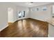 Open-concept living room with light gray walls, archway, wood-look flooring, and glass doors to patio at 2679 Rainbow Springs Ln, Orlando, FL 32828