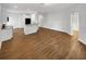 Spacious living room with wood-look floors offering seamless transition into the adjacent kitchen area at 2679 Rainbow Springs Ln, Orlando, FL 32828