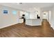 Bright open-concept living space featuring wood-look floors seamlessly connecting the kitchen at 2679 Rainbow Springs Ln, Orlando, FL 32828