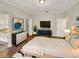 Spacious main bedroom featuring neutral decor, hardwood floors, and ample closet space at 2679 Rainbow Springs Ln, Orlando, FL 32828