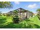 Well maintained backyard with green lawn and a screened patio at 2895 Apache Ct, The Villages, FL 32163