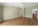 The primary bedroom features wood-look flooring and neutral paint at 2895 Apache Ct, The Villages, FL 32163