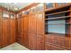 Spacious walk-in closet features custom shelving and cabinets with drawers at 2895 Apache Ct, The Villages, FL 32163