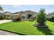 Charming home showcasing lush green lawn and beautiful landscaping at 2895 Apache Ct, The Villages, FL 32163