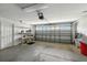 Spacious two-car garage with shelving for storage and an automatic door at 2895 Apache Ct, The Villages, FL 32163
