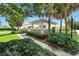 Neighborhood gazebo surrounded by mature plants and trees at 2895 Apache Ct, The Villages, FL 32163
