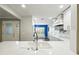 Bright kitchen featuring white cabinets, white countertops and a window seat at 2895 Apache Ct, The Villages, FL 32163