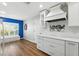 Kitchen featuring white cabinets and counters, stainless steel appliances, and hardwood floors at 2895 Apache Ct, The Villages, FL 32163