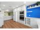Kitchen features white cabinets, stainless steel appliances, a modern sink, and hardwood flooring at 2895 Apache Ct, The Villages, FL 32163