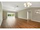 Inviting living area featuring wood-look floors and direct access to the bright sunroom at 2895 Apache Ct, The Villages, FL 32163