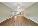 Open-concept room with wood-look floors and neutral walls leading to other rooms at 2895 Apache Ct, The Villages, FL 32163