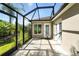 Screened in patio with a door leading to the backyard and adjacent to the house at 2895 Apache Ct, The Villages, FL 32163