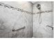 Shower featuring gray patterned tile, safety bar, shower head and decorative mosaic border at 2895 Apache Ct, The Villages, FL 32163