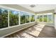Bright sunroom with expansive windows and wood-look flooring at 2895 Apache Ct, The Villages, FL 32163