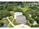 Stunning aerial shot of a community pool and clubhouse nestled amongst mature trees and lush landscapes at 30210 Donnington Loop, Mount Dora, FL 32757