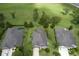 An aerial view shows this home nestled in a peaceful neighborhood with well-manicured lawns at 30210 Donnington Loop, Mount Dora, FL 32757