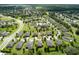 Expansive aerial view of a residential neighborhood with well-manicured lawns and tree-lined streets at 30210 Donnington Loop, Mount Dora, FL 32757