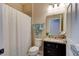 Well-maintained bathroom with granite vanity, shower with curtain, and neutral color palette at 30210 Donnington Loop, Mount Dora, FL 32757
