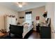Cozy bedroom with hardwood floors, a ceiling fan, and a window providing natural light at 30210 Donnington Loop, Mount Dora, FL 32757