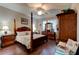 A traditionally designed bedroom with dark wooden furniture and a four-poster bed at 30210 Donnington Loop, Mount Dora, FL 32757