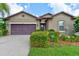 Charming single-Gathering home featuring a well-maintained lawn and a two-car garage in a lovely neighborhood at 30210 Donnington Loop, Mount Dora, FL 32757