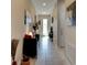 A long hallway with neutral walls, ceramic tile flooring, and recessed lighting creates a welcoming atmosphere at 30210 Donnington Loop, Mount Dora, FL 32757
