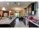 A well-lit kitchen with dark cabinets and an island at 30210 Donnington Loop, Mount Dora, FL 32757
